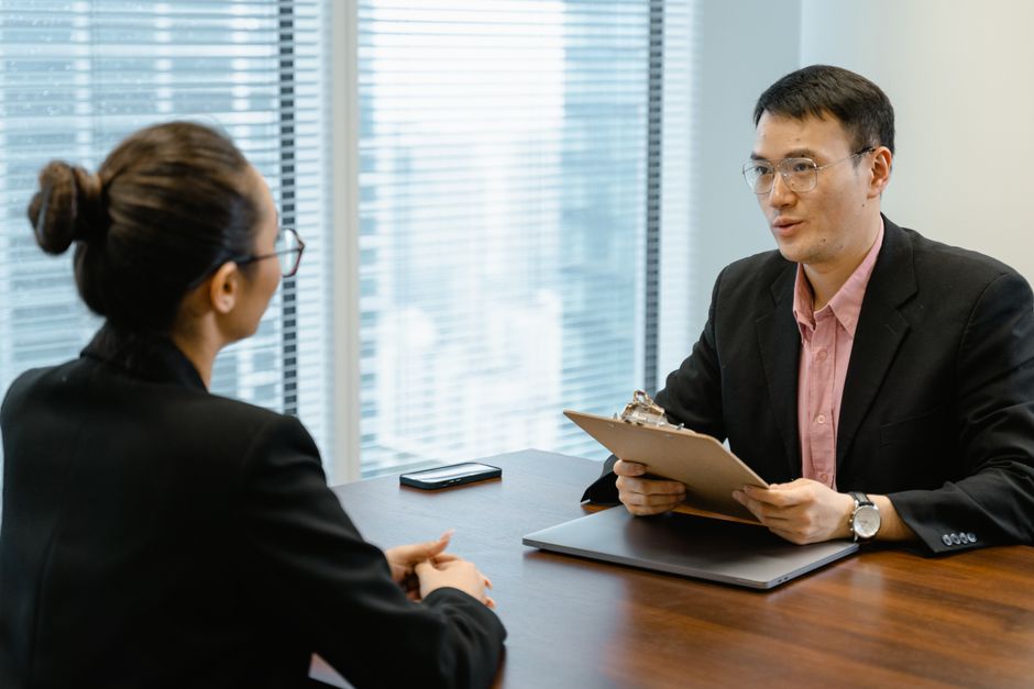 A person reviewing notes before a video interview at home